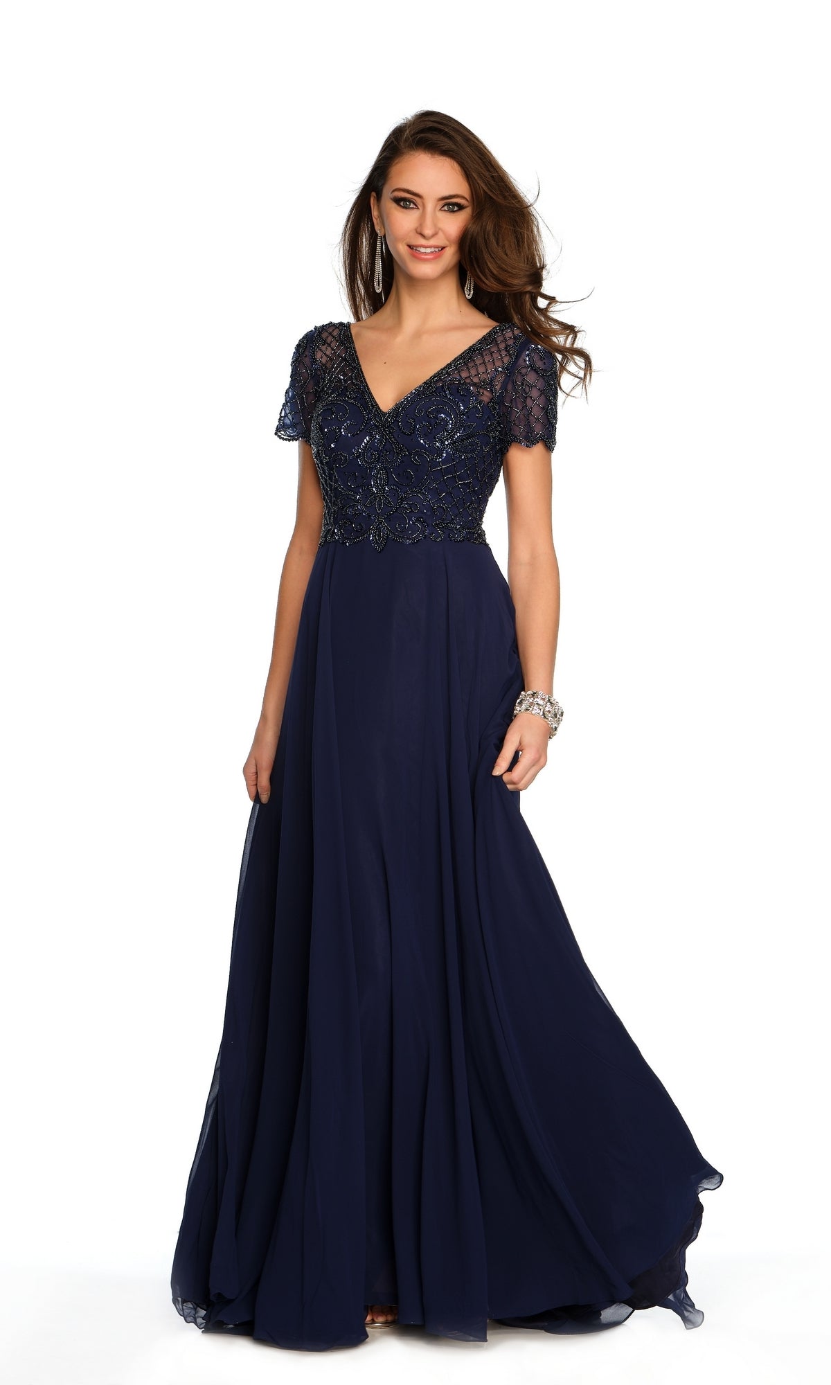 A woman stands against a white background wearing the Long Formal Dress A9322 by Dave and Johnny, featuring a navy blue beaded bodice, short sleeves, and a flowing A-line skirt.